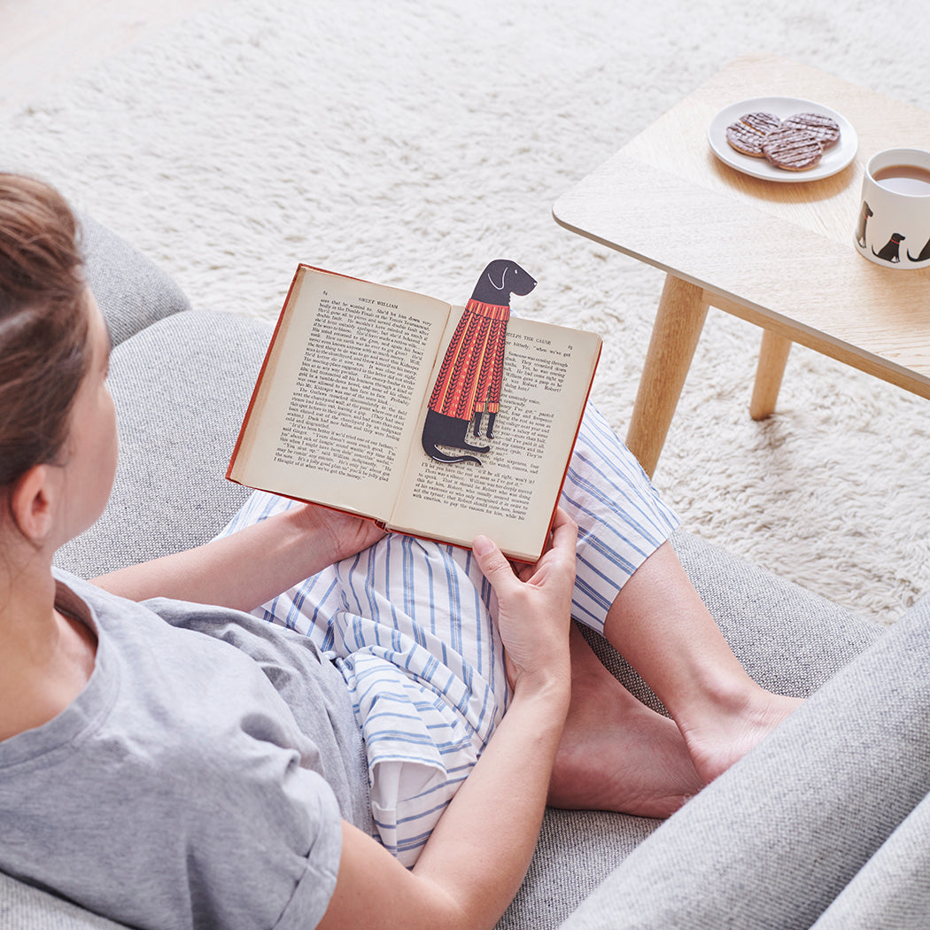 Woman reading a book with a Black Labrador bookmark and matching Black Labrador mug by Sweet William Designs