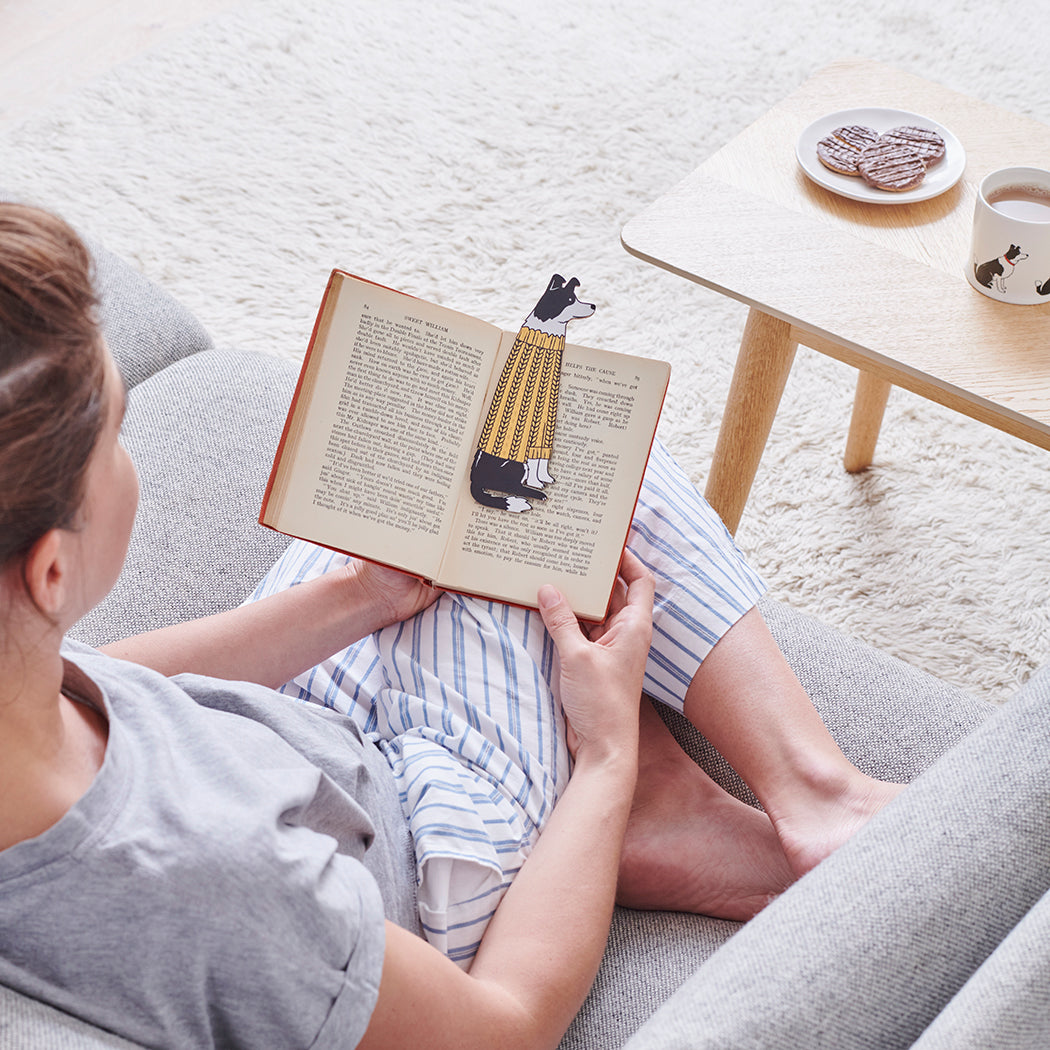 Woman reading a book with a Border Collie bookmark and matching Border Collie mug by Sweet William Designs