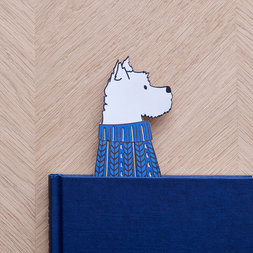 Westie bookmark peeking out of navy book — illustrated dog in blue jumper, vegan PU leather bookmark by Sweet William Designs