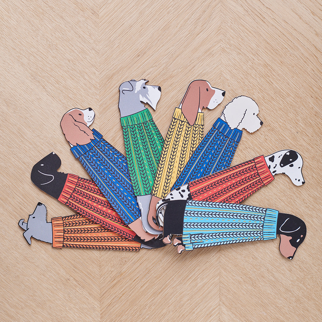 Illustrated dog breed bookmarks in colourful jumpers laid flat on a table — dog lover gifts by Sweet William Designs