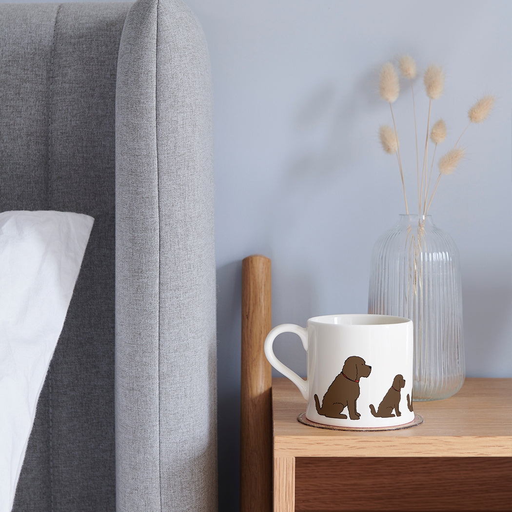 Sweet William Chocolate Cockapoo Mug on a bedside table — illustrated Cockapoo repeat pattern ceramic mug