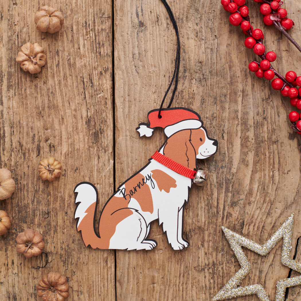 Personalised Cavalier King Charles Spaniel Christmas decoration with name — wooden dog decoration with Father Christmas hat and jingle bell collar, thoughtful dog lover gift by Sweet William Designs