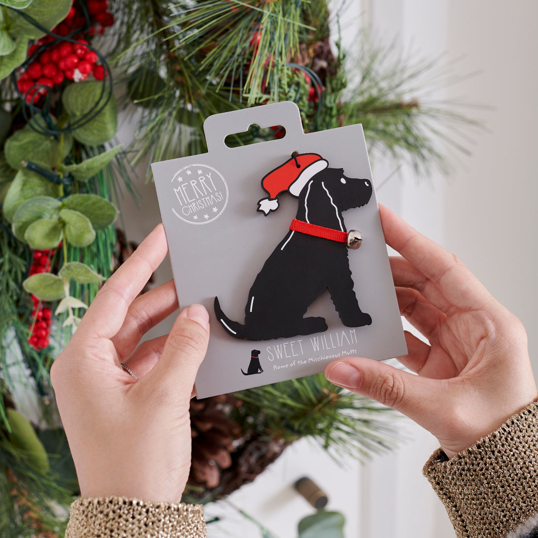 Black Cocker Spaniel Christmas tree decoration held in hands on backing card — Father Christmas hat and jingle bell collar, dog lover gift by Sweet William Designs