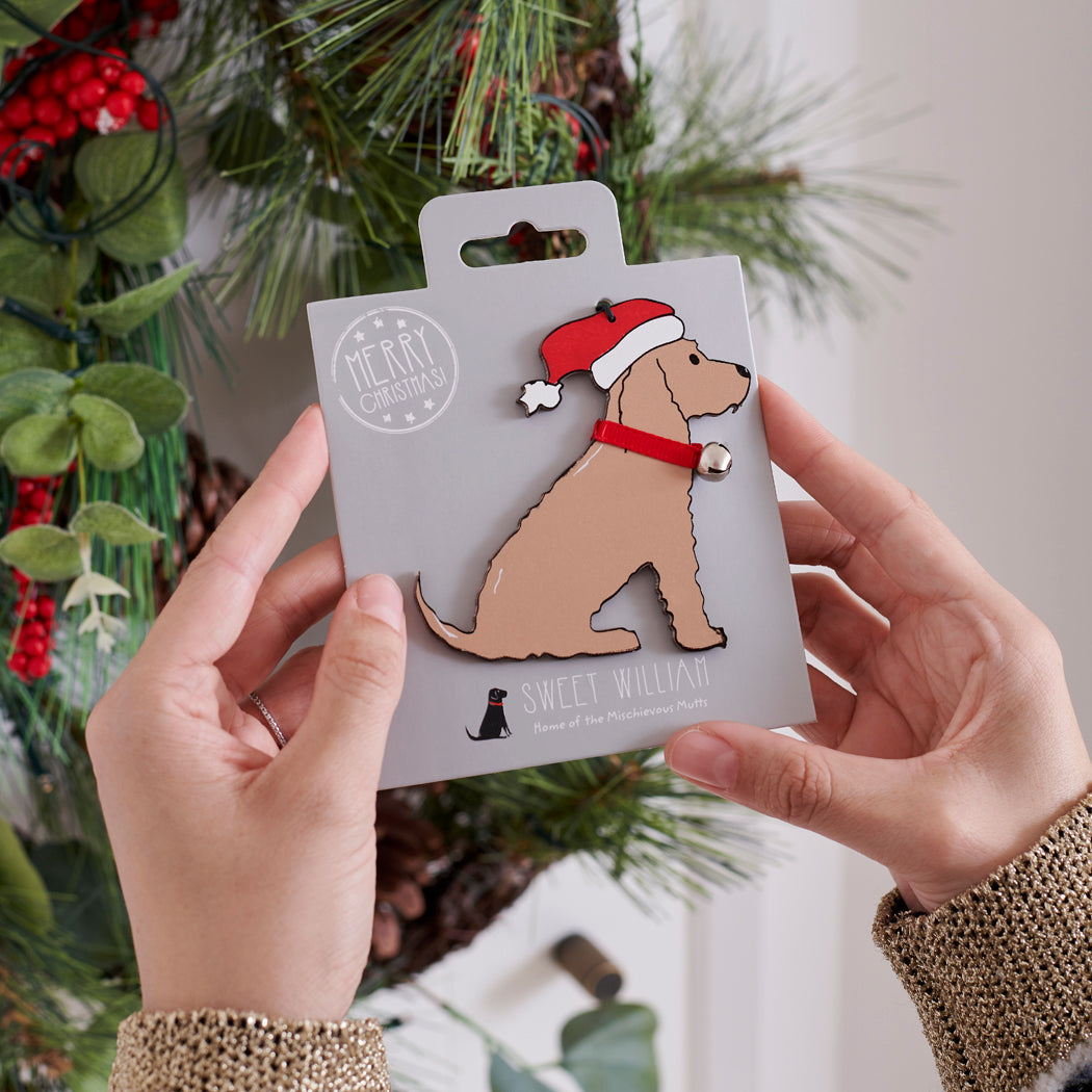 Golden Cocker Spaniel Christmas tree decoration held in hands on backing card — Father Christmas hat and jingle bell collar, dog lover gift by Sweet William Designs