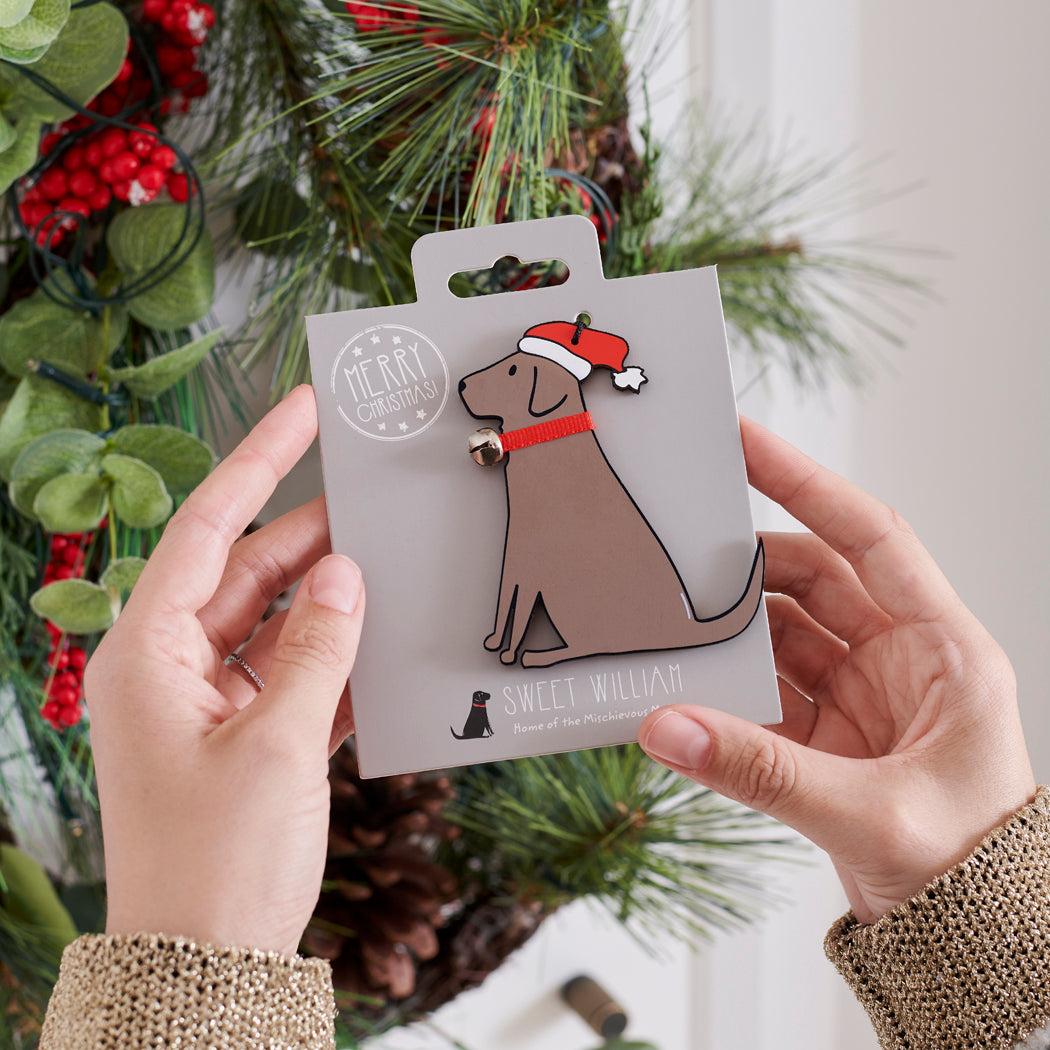 Chocolate Labrador Christmas tree decoration held in hands on backing card — Father Christmas hat and jingle bell collar, dog lover gift by Sweet William Designs