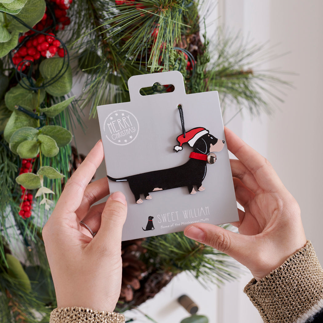Dachshund Christmas tree decoration held in hands on backing card — Father Christmas hat and jingle bell collar, dog lover gift by Sweet William Designs