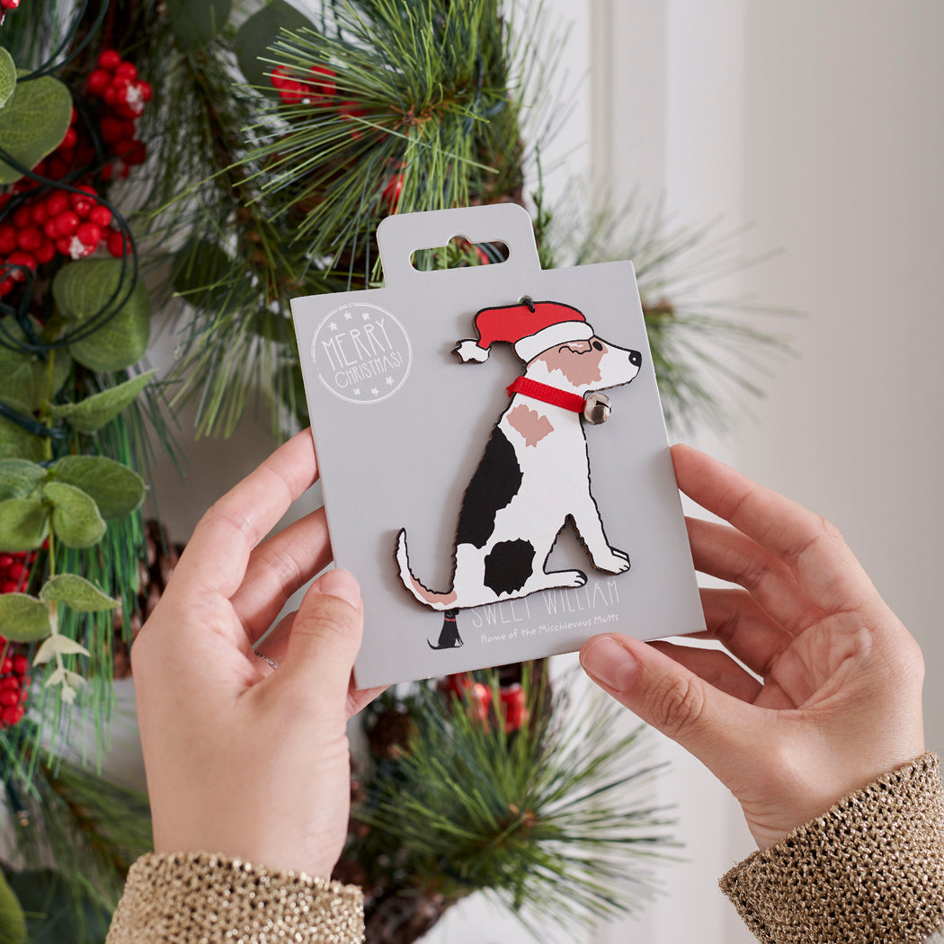 Jack Russell Christmas tree decoration held in hands on backing card — Father Christmas hat and jingle bell collar, dog lover gift by Sweet William Designs