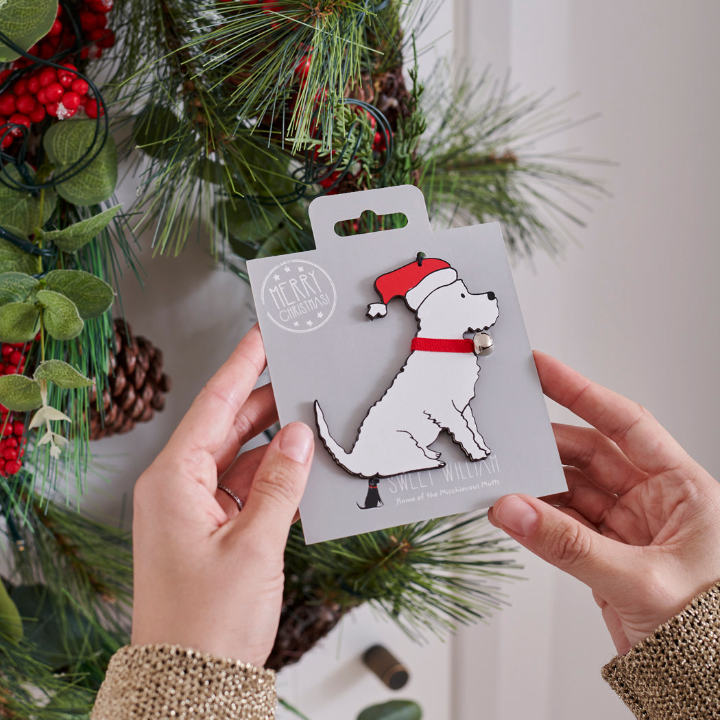 Westie Christmas tree decoration held in hands on backing card — Father Christmas hat and jingle bell collar, dog lover gift by Sweet William Designs