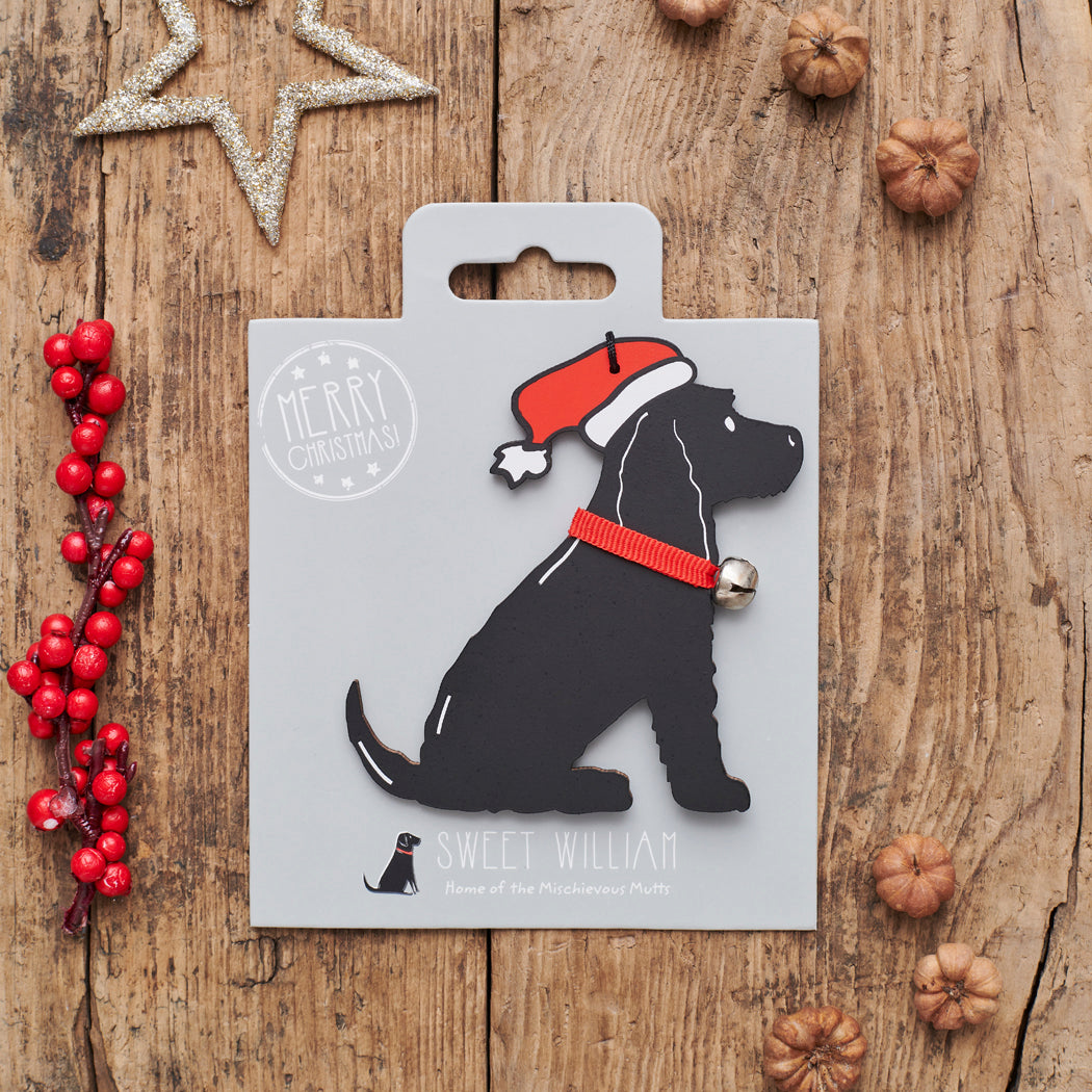 Black Cocker Spaniel Christmas decoration on backing card — wooden dog decoration with Father Christmas hat and jingle bell collar, festive dog lover gift by Sweet William Designs