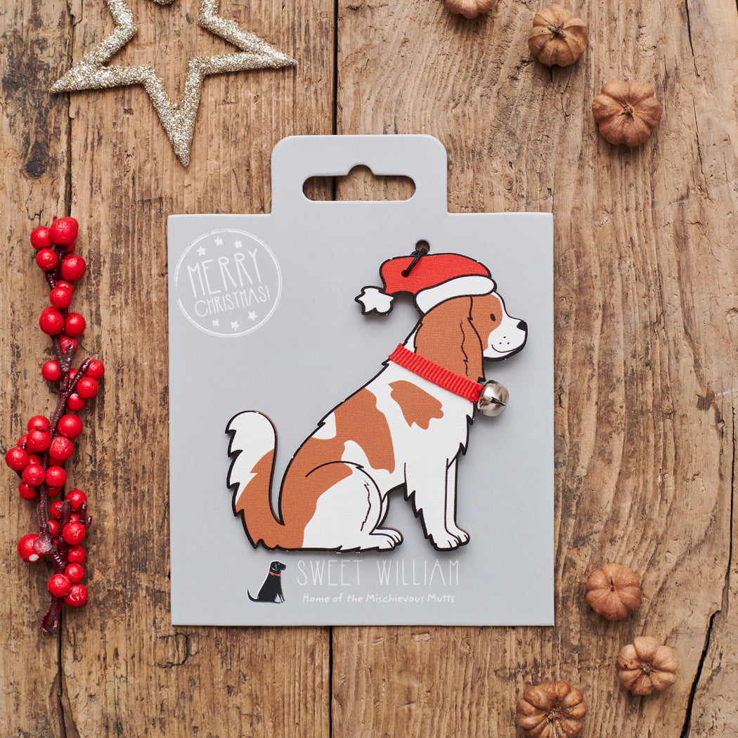 Cavalier King Charles Spaniel Christmas decoration on backing card — wooden dog decoration with Father Christmas hat and jingle bell collar, festive dog lover gift by Sweet William Designs