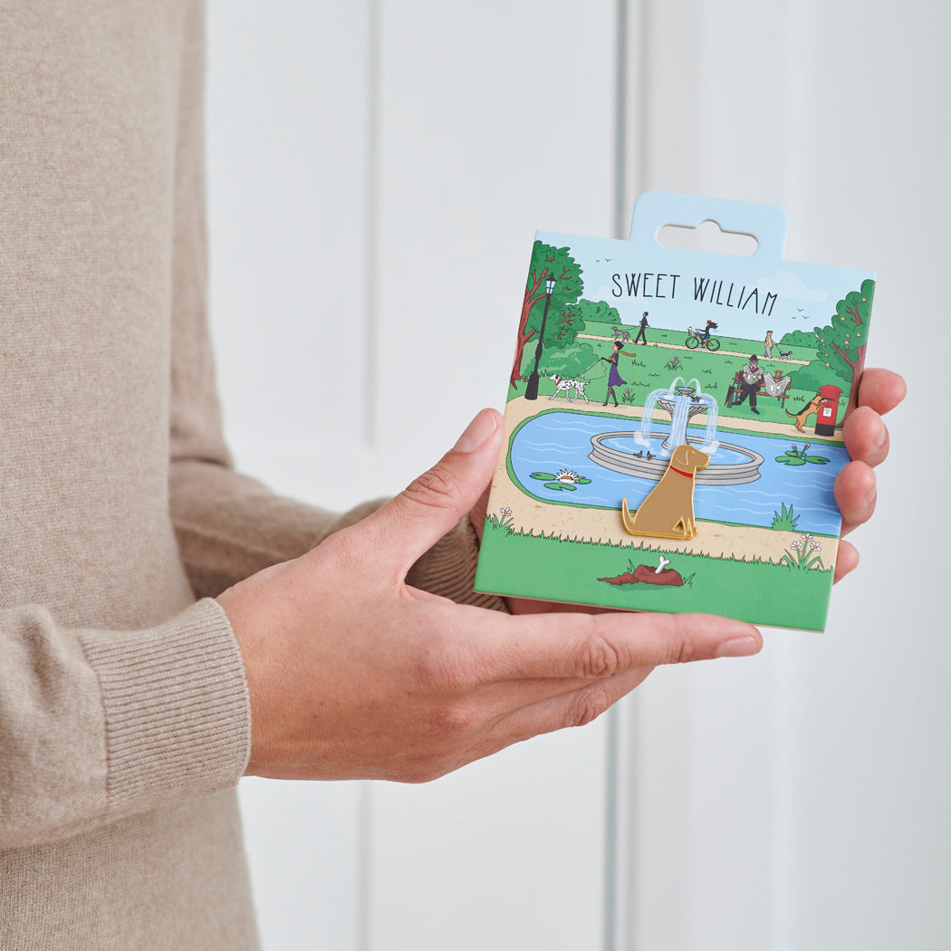Yellow Labrador enamel dog pin held in hands on illustrated park backing card — gold-plated dog lover gift by Sweet William Designs