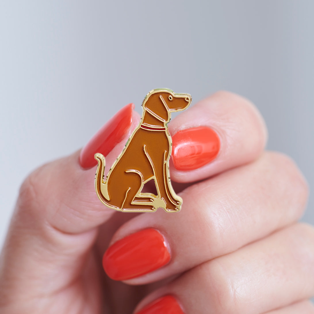 Close-up of a Vizsla enamel pin held in hand, showing the detailed Vizsla illustration by Sweet William Designs