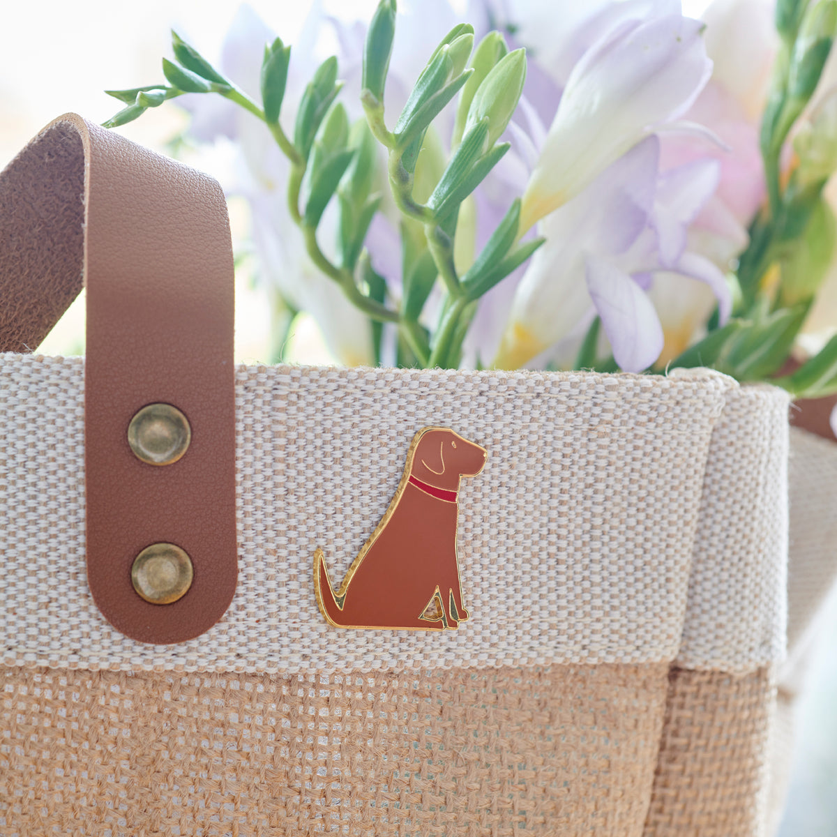 Close up of Fox Red Labrador enamel pin styled on Sweet William tote bag, perfect gift for Labrador lovers