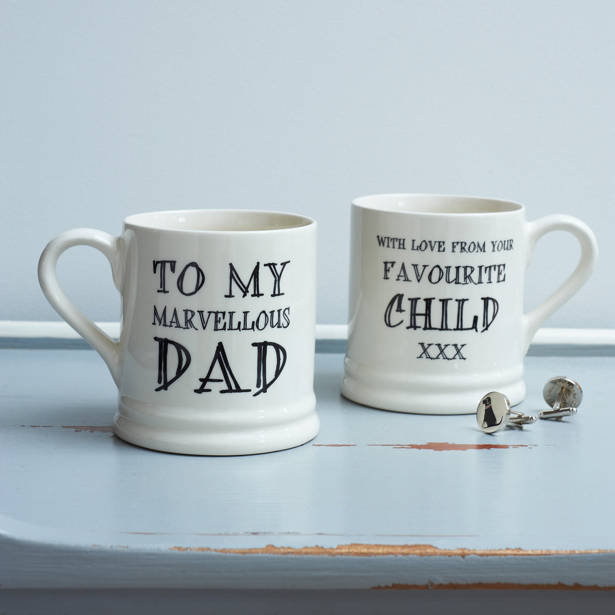 Ceramic Dad mug showing “To My Marvellous Dad” on the front and “With Love From Your Favourite Child xxx” on the reverse, styled with Labrador silver cufflinks by Sweet William Designs