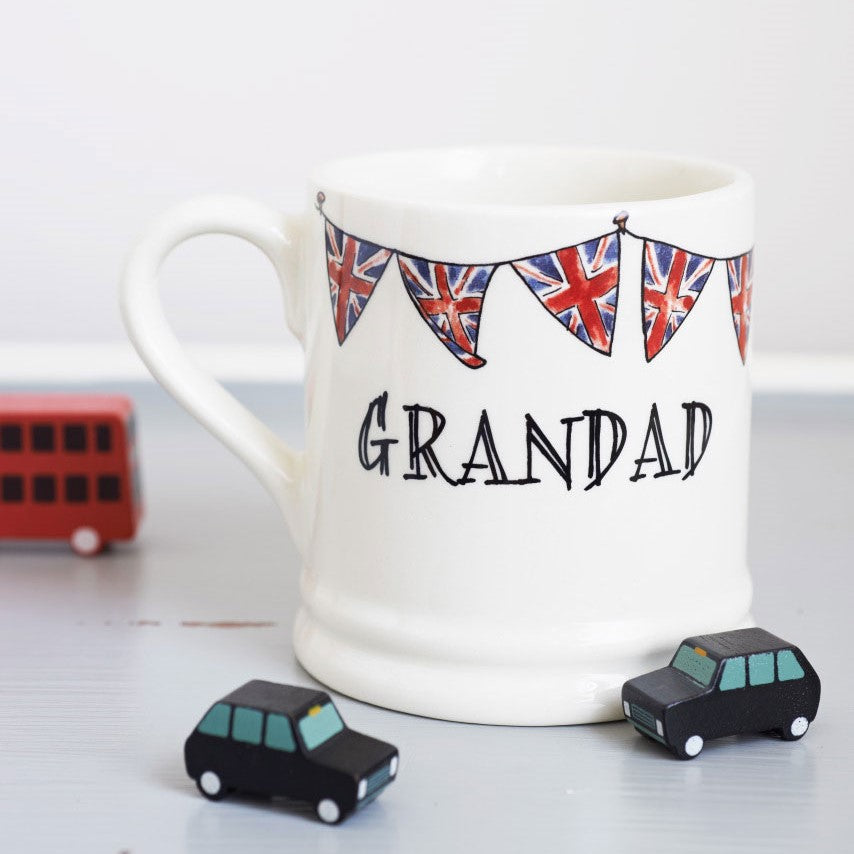 Ceramic Grandad mug with hand-drawn Union Jack bunting and two small black toy cars, a thoughtful gift for a much-loved grandfather
