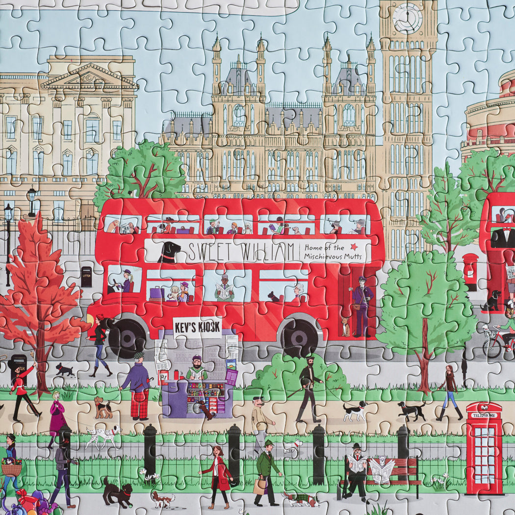 Close-up of Dog Walkers of London jigsaw puzzle showing Big Ben, red double-decker bus and Sweet William Designs branding — London dog lover gift
