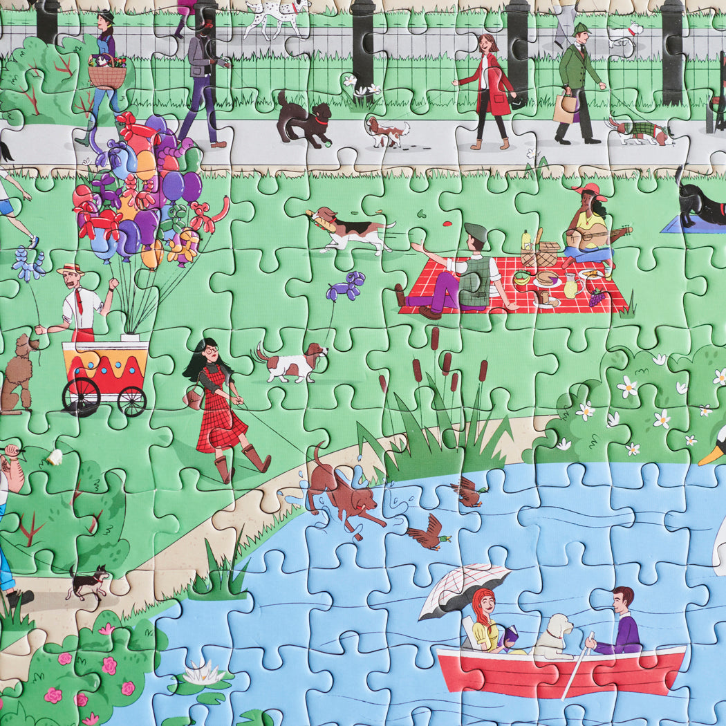 Close-up of Dog Walkers of London jigsaw puzzle showing park scene with dogs, picnickers, balloon seller and lake — 1000 piece London puzzle