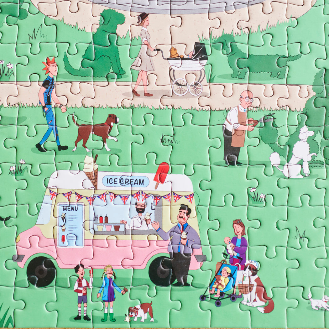 Close-up of Dog Walkers of London jigsaw puzzle showing park scene with ice cream van, dogs and families — illustrated London dog lover gift