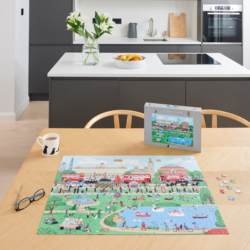 Dog Walkers of London jigsaw puzzle being assembled on a kitchen table with puzzle box — 1000 piece London dog lover gift by Sweet William Designs