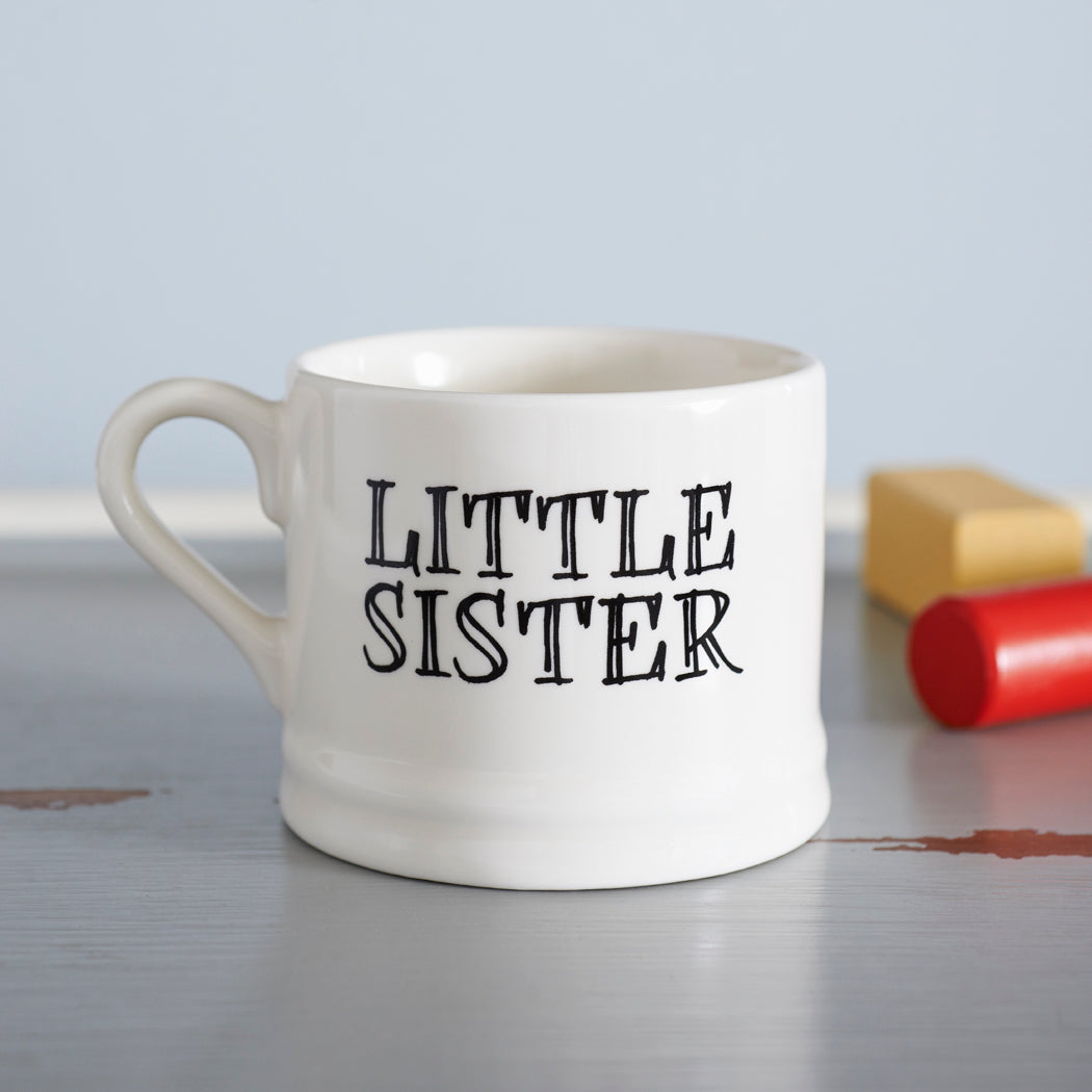 Ceramic “Little Sister” mug photographed beside colourful crayons as a lovely gift for a younger sister