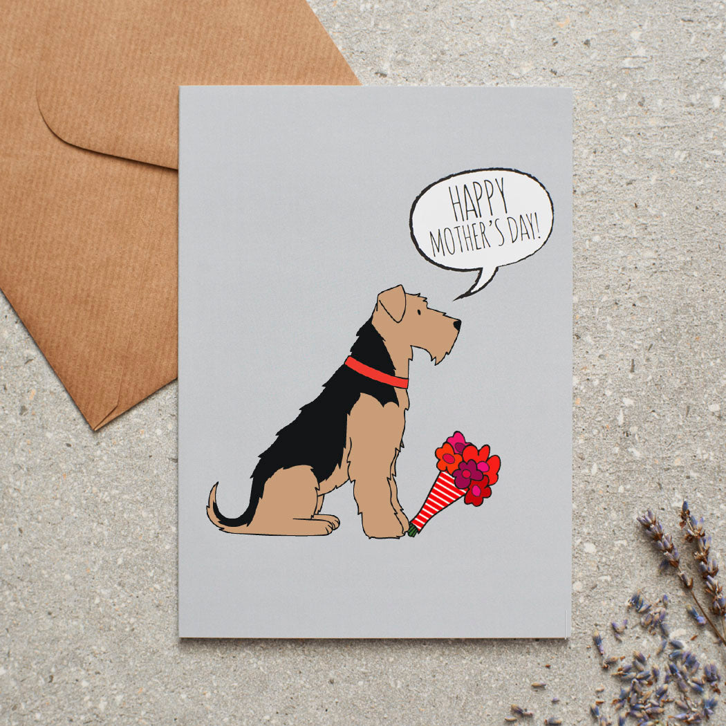 Airedale Terrier Mother's Day card — illustrated Airedale holding a bouquet of flowers and 'Happy Mother's Day' message, dog lover gift by Sweet William Designs