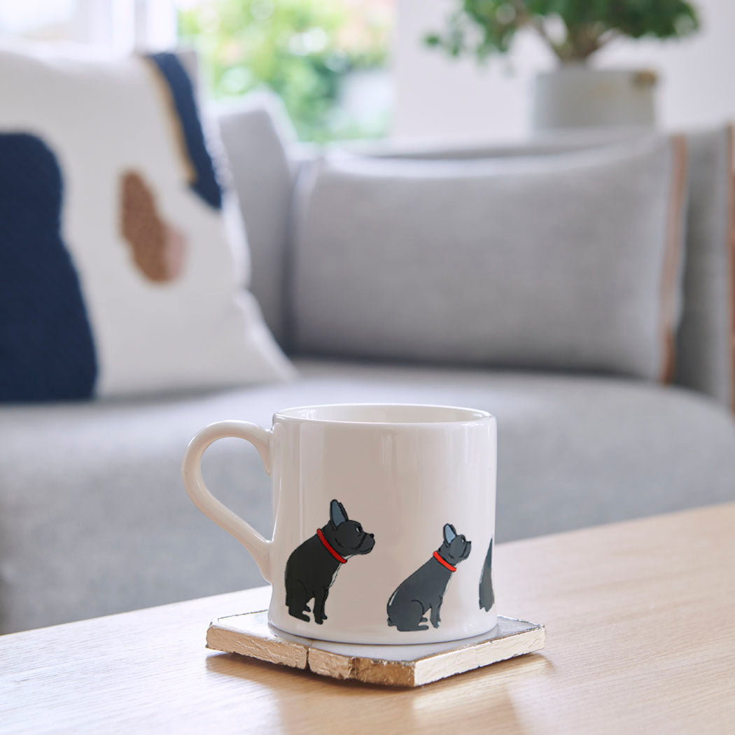 Sweet William French Bulldog Mug on a coffee table — illustrated French Bulldog repeat pattern ceramic mug