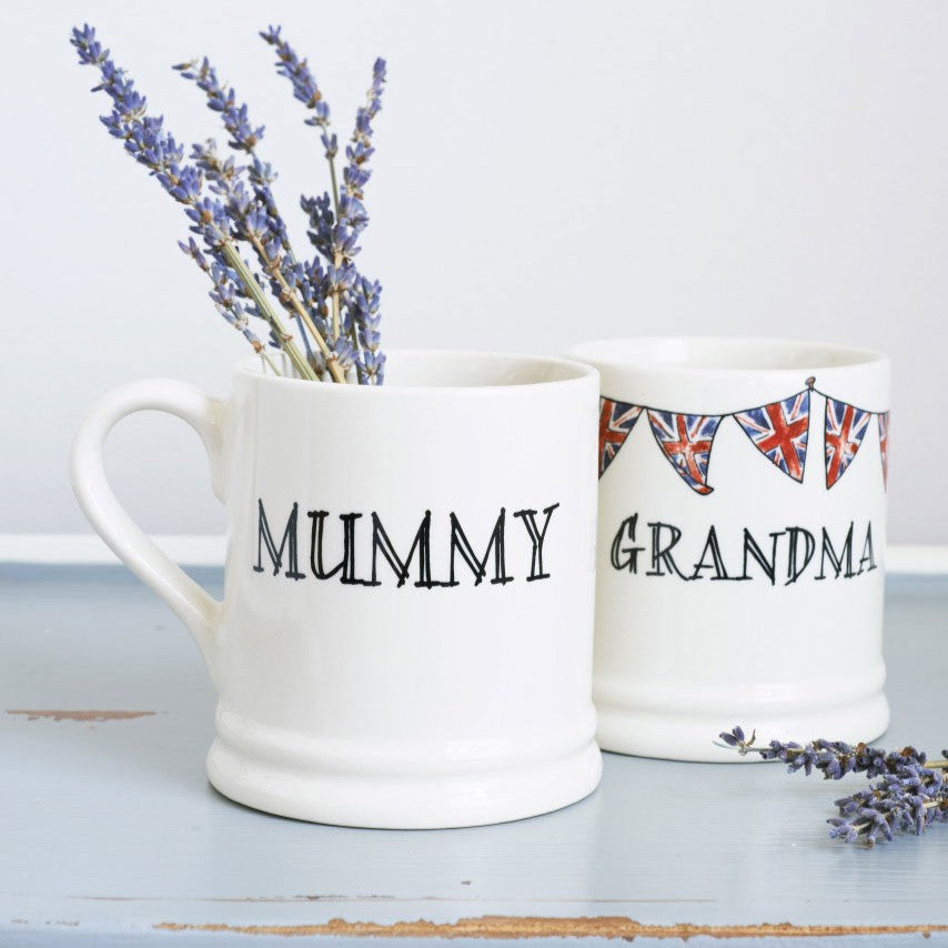 Ceramic Grandma and Mummy mugs displayed together, featuring hand-drawn Union Jack bunting by Sweet William Designs