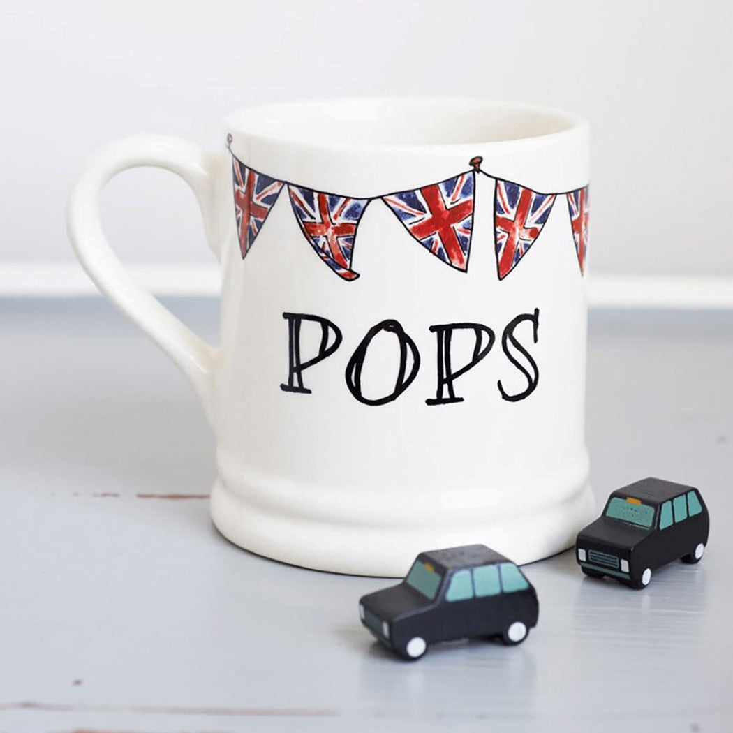 Ceramic Pops mug with hand-drawn Union Jack bunting and two small black toy cars, a playful gift for Dad by Sweet William Designs