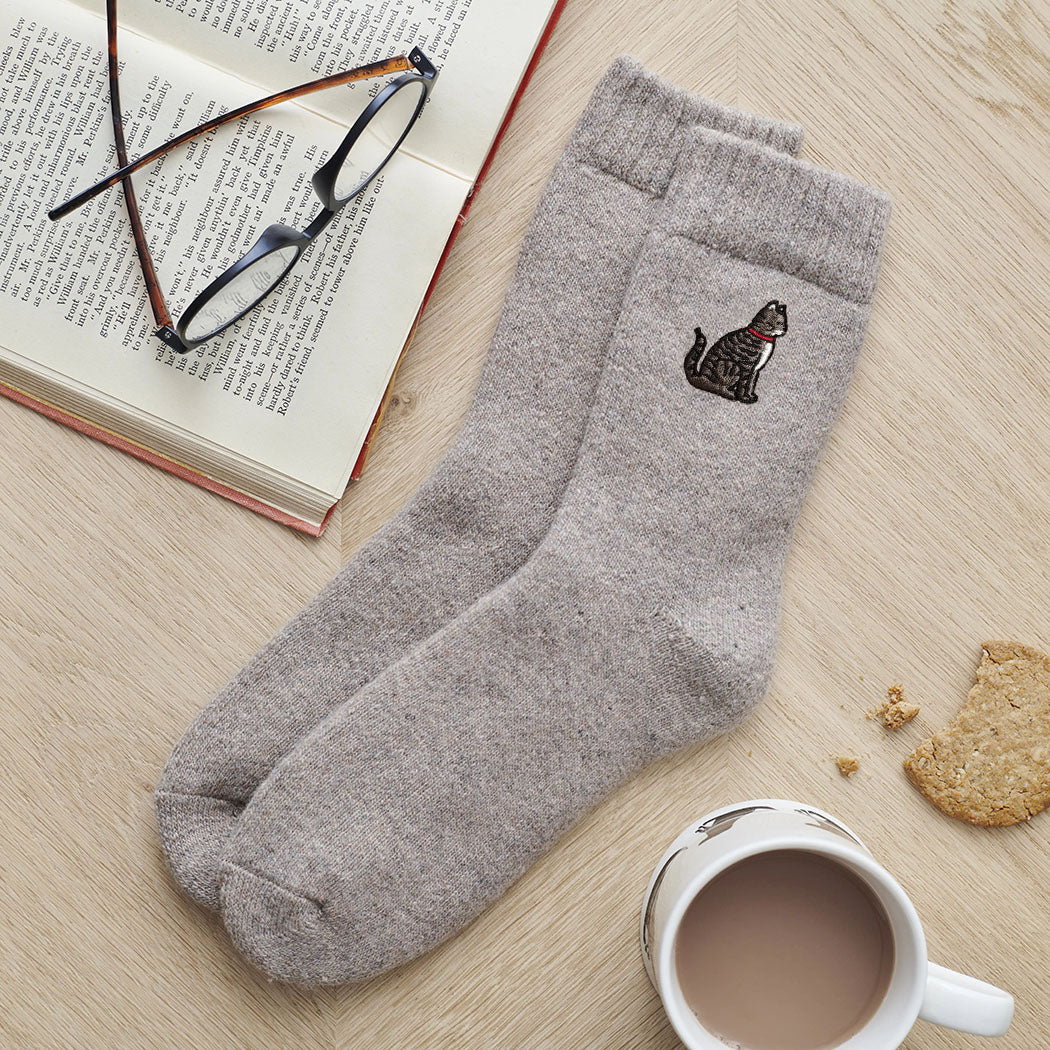 Tabby cat embroidered wool socks laid flat with book, glasses and cup of tea — cosy cat lover gift by Sweet William Designs