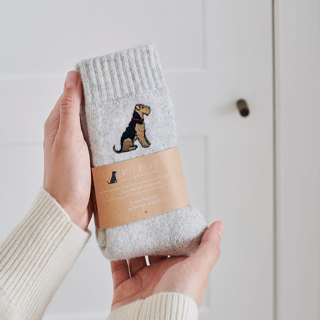 Airedale Terrier socks in hand – embroidered wool dog lover gift