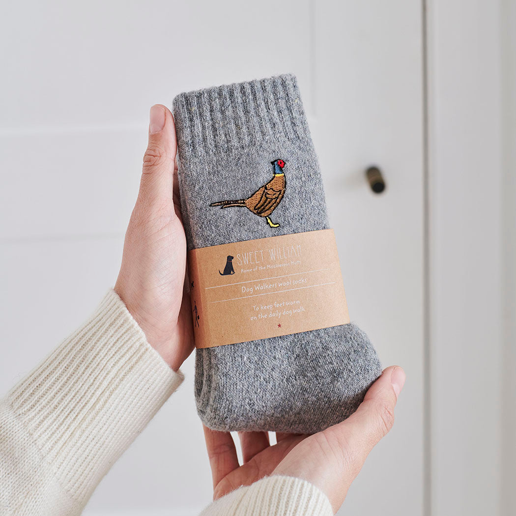 Pheasant wool socks held in hands with Sweet William Designs branded band — soft wool blend pheasant lover gift
