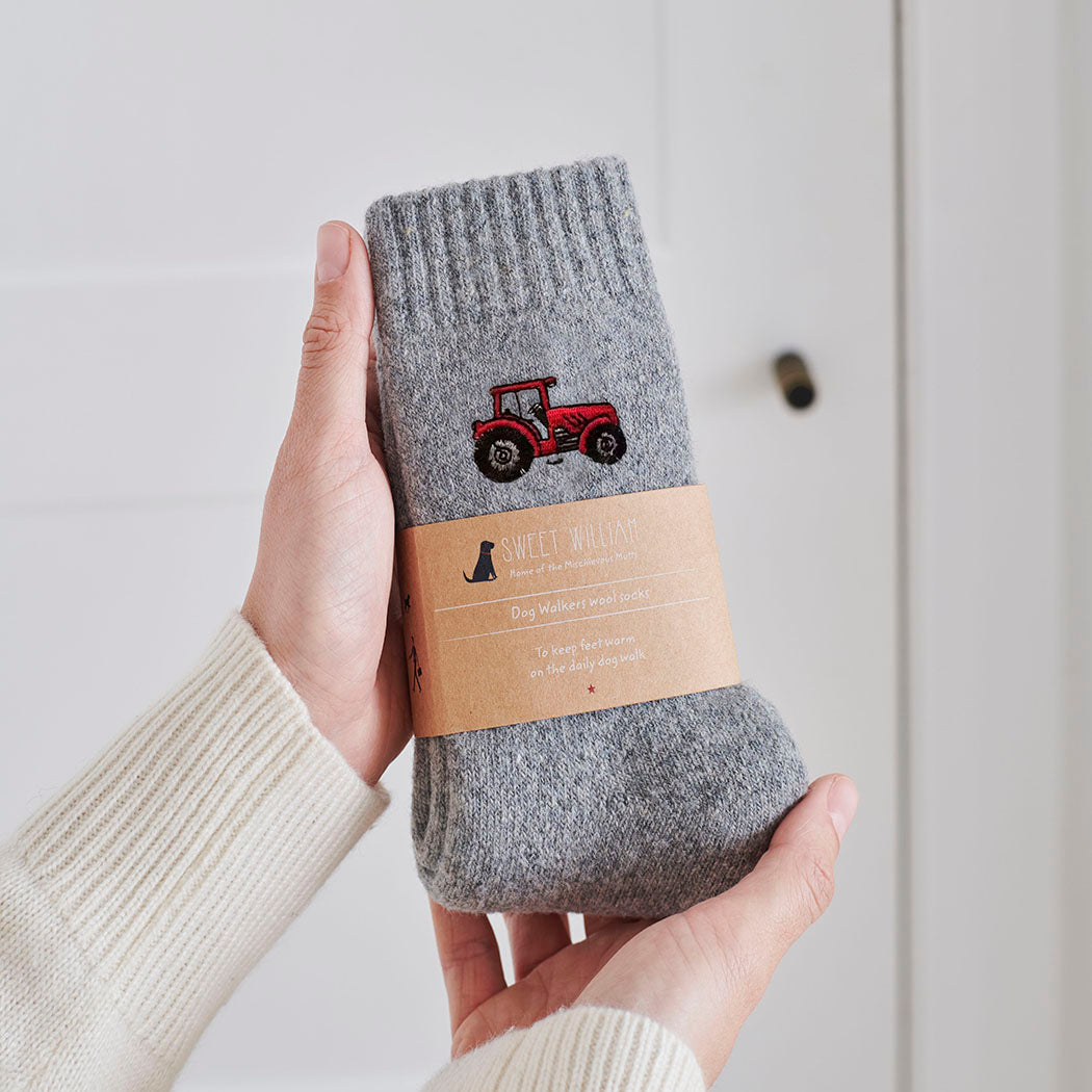 Tractor embroidered wool socks held in hands with Sweet William Designs branded band — soft wool blend countryside gift