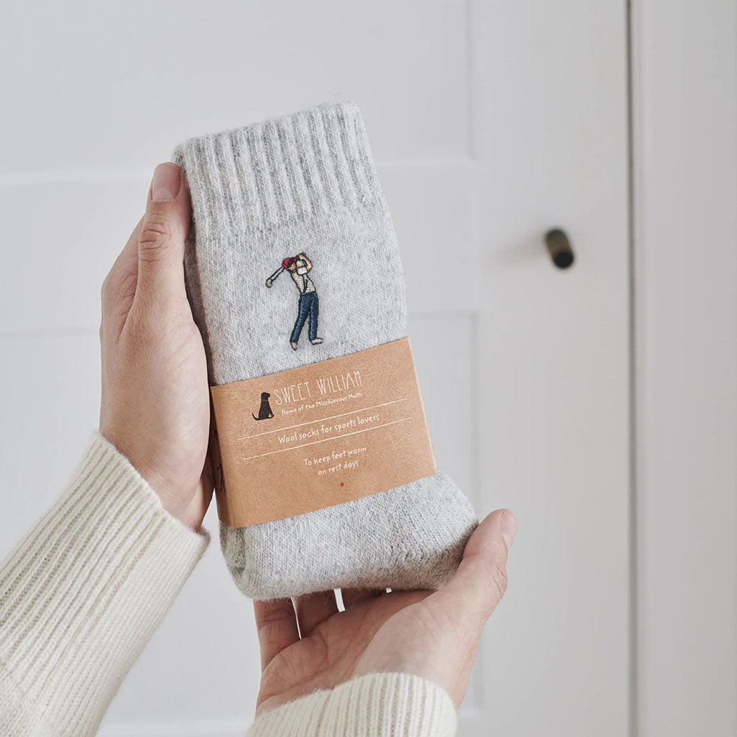 Golfer embroidered wool socks held in hands with Sweet William Designs branded band — soft wool blend golf lover gift