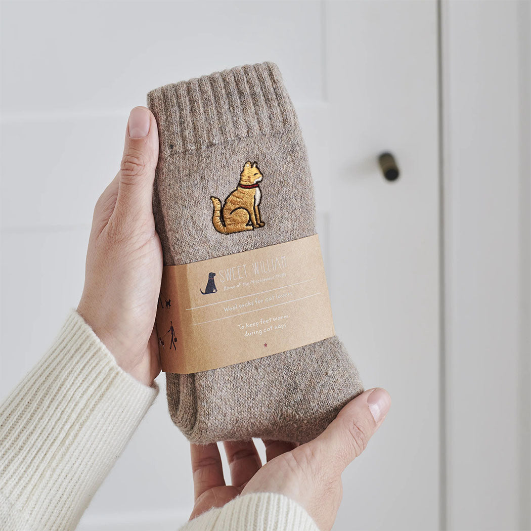 Ginger cat wool socks held in hands with Sweet William Designs branded band — soft wool blend cat lover gift
