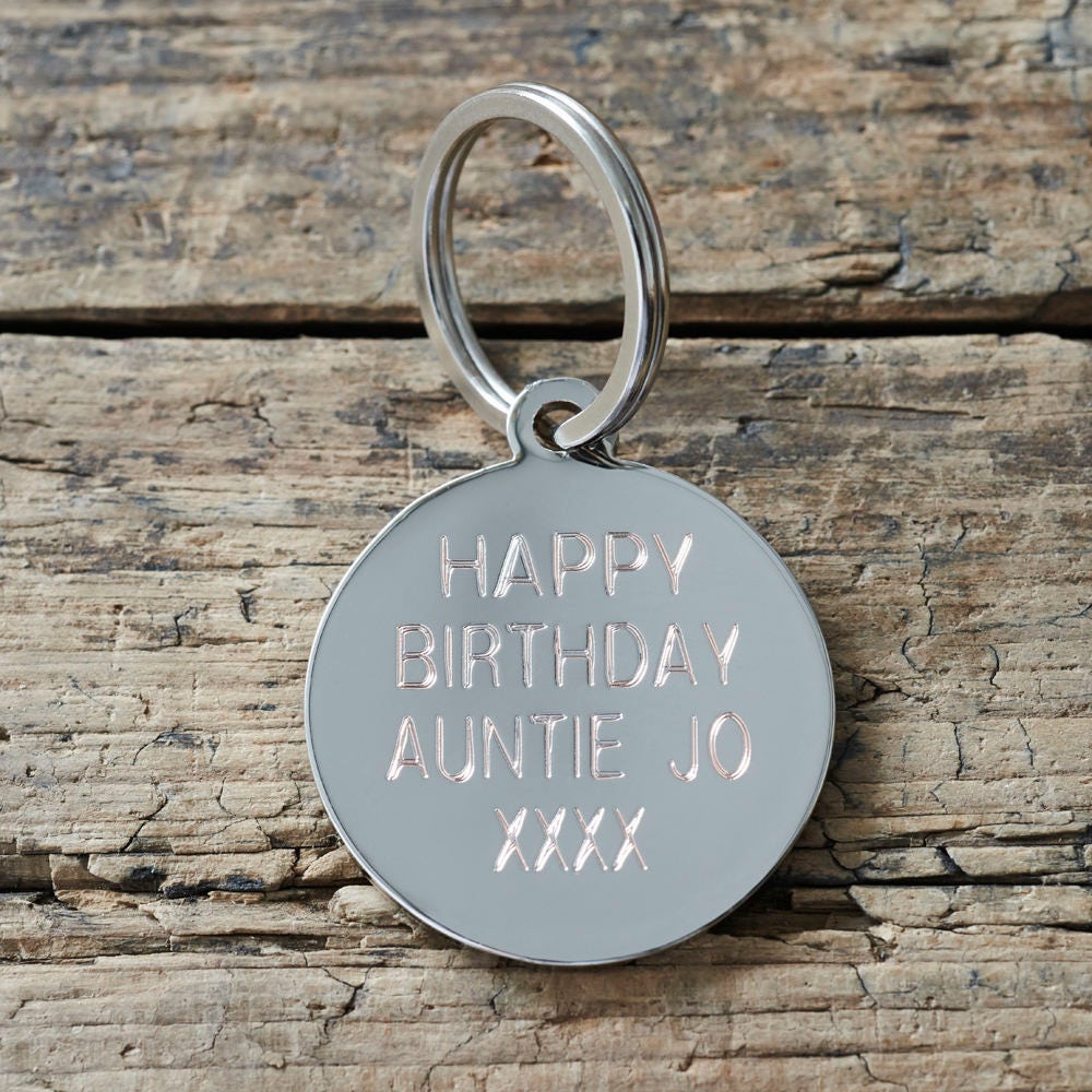 Personalised silver-plated brass tag engraved with custom message — can be used as a dog tag or keyring, thoughtful dog lover gift