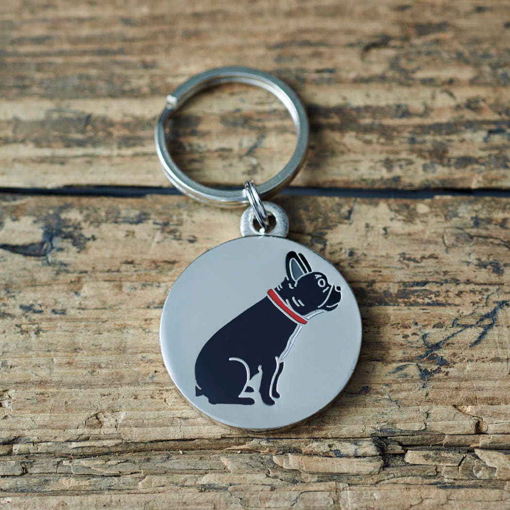 Close-up of French Bulldog dog ID tag — silver-plated brass with illustrated French Bulldog design, personalised dog tag by Sweet William Designs