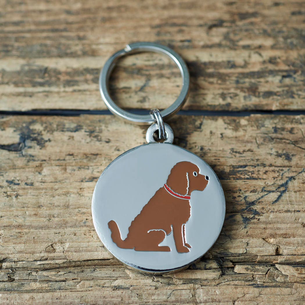 Close-up of Chocolate Cockapoo / Labradoodle dog ID tag — silver-plated brass with illustrated Chocolate Cockapoo design, personalised dog tag by Sweet William Designs