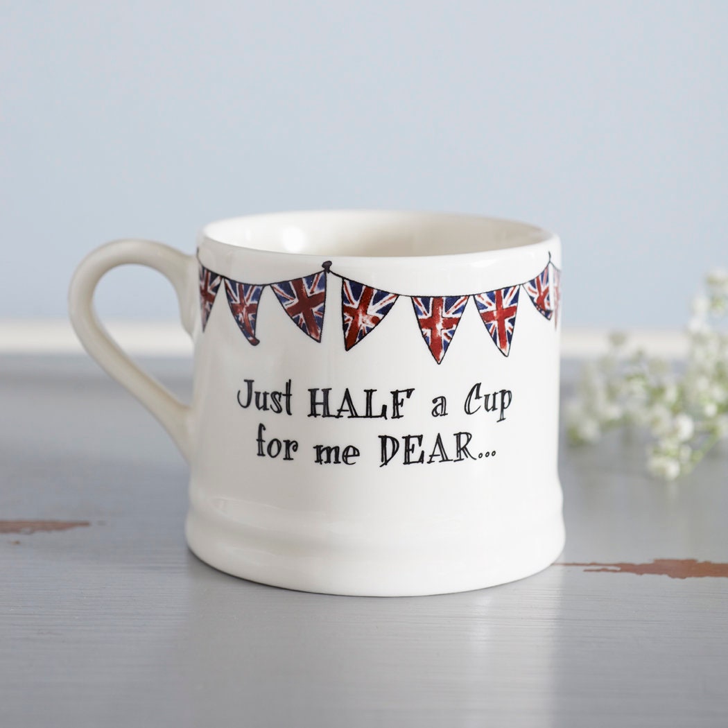 Porcelain half-cup mug with Union Jack bunting and the playful message, “Just half a cup for me dear…”