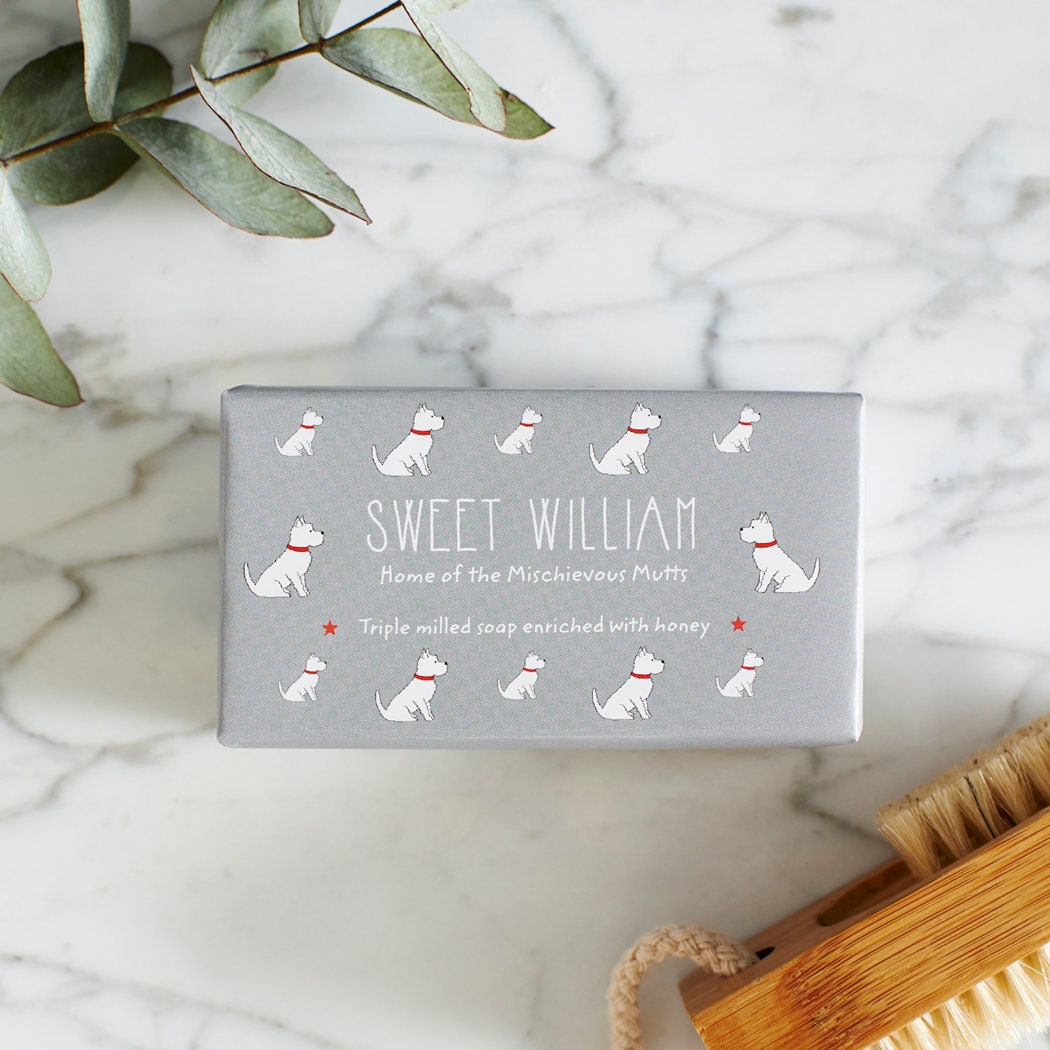 Close-up of Westie soap packaging — Sweet William triple milled soap enriched with honey, illustrated Westie repeat pattern