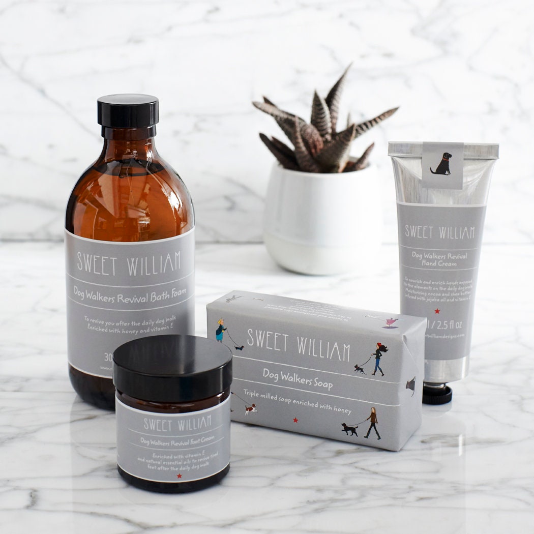 Dog Walkers Revival Collection arranged on a marble surface featuring bath foam, soap, foot cream and hand cream — thoughtful dog walker gift by Sweet William Designs