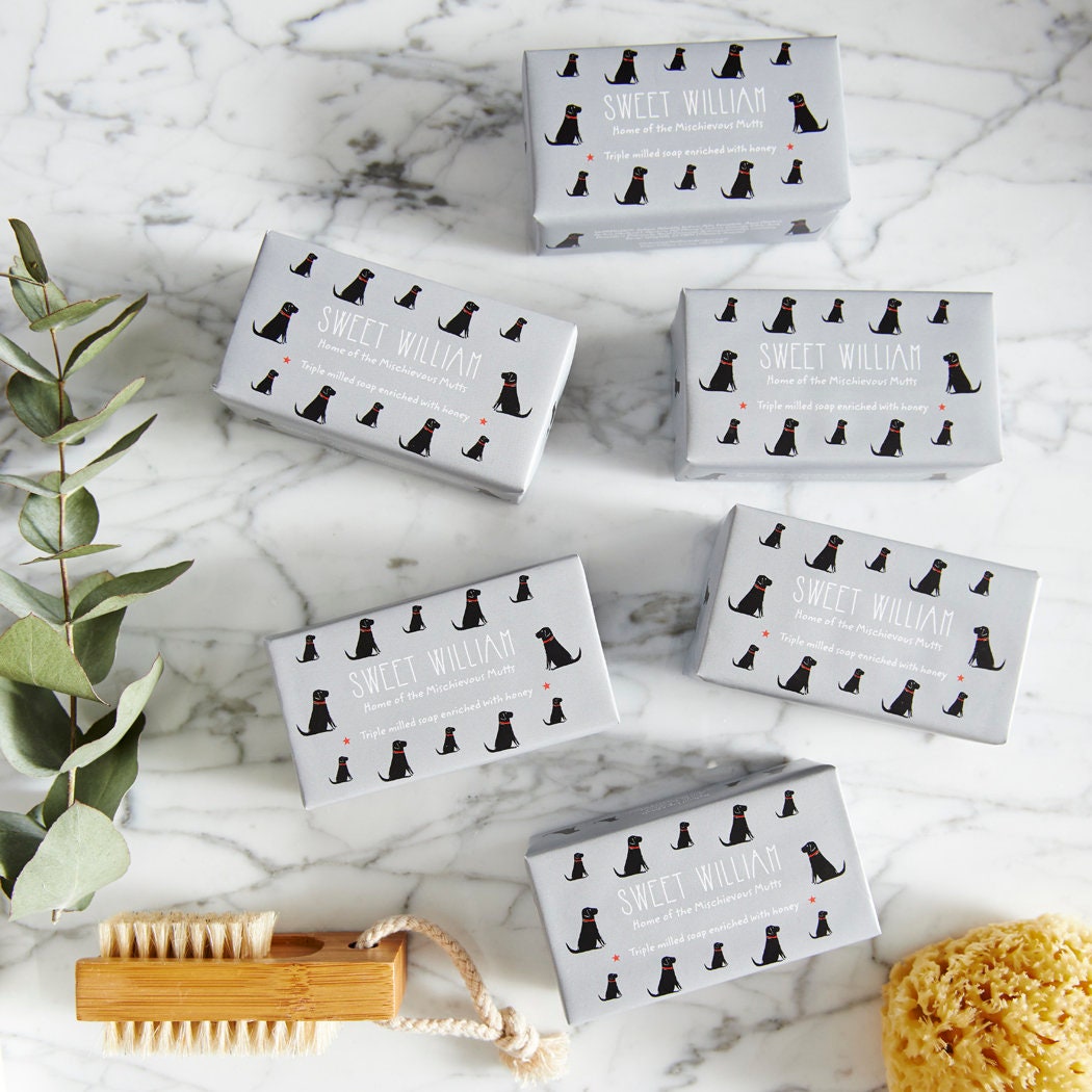 Collection of Black Labrador triple milled soaps on marble surface — honey-enriched luxury dog lover gift by Sweet William Designs