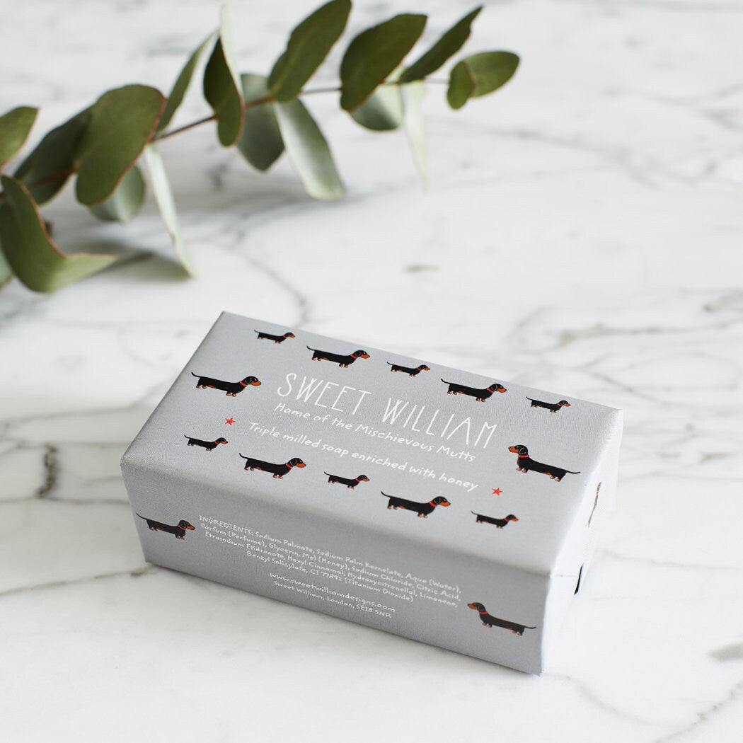 Dachshund triple milled soap on marble surface — honey-enriched luxury soap in Dachshund illustrated packaging by Sweet William Designs