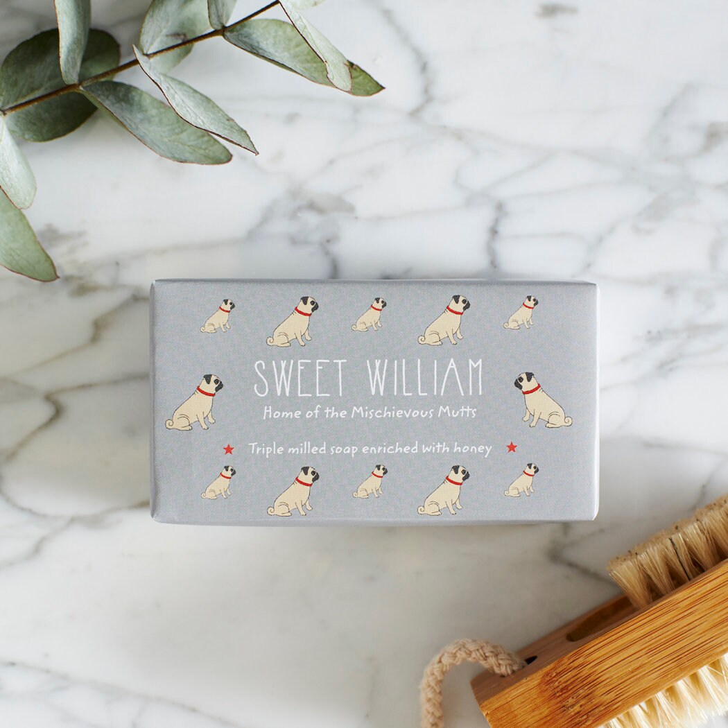 Close-up of Pug soap packaging — Sweet William triple milled soap enriched with honey, illustrated Pug repeat pattern