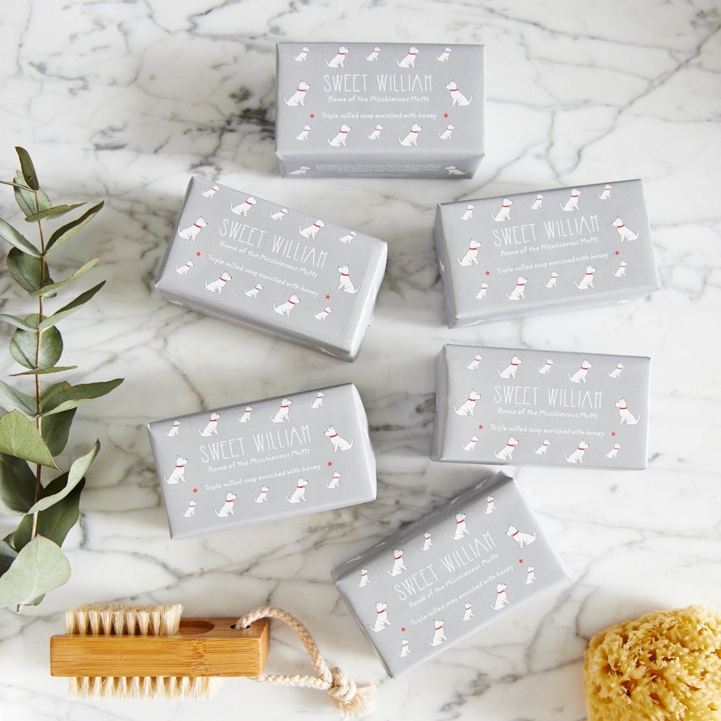 Collection of Westie triple milled soaps on marble surface — honey-enriched luxury dog lover gift by Sweet William Designs