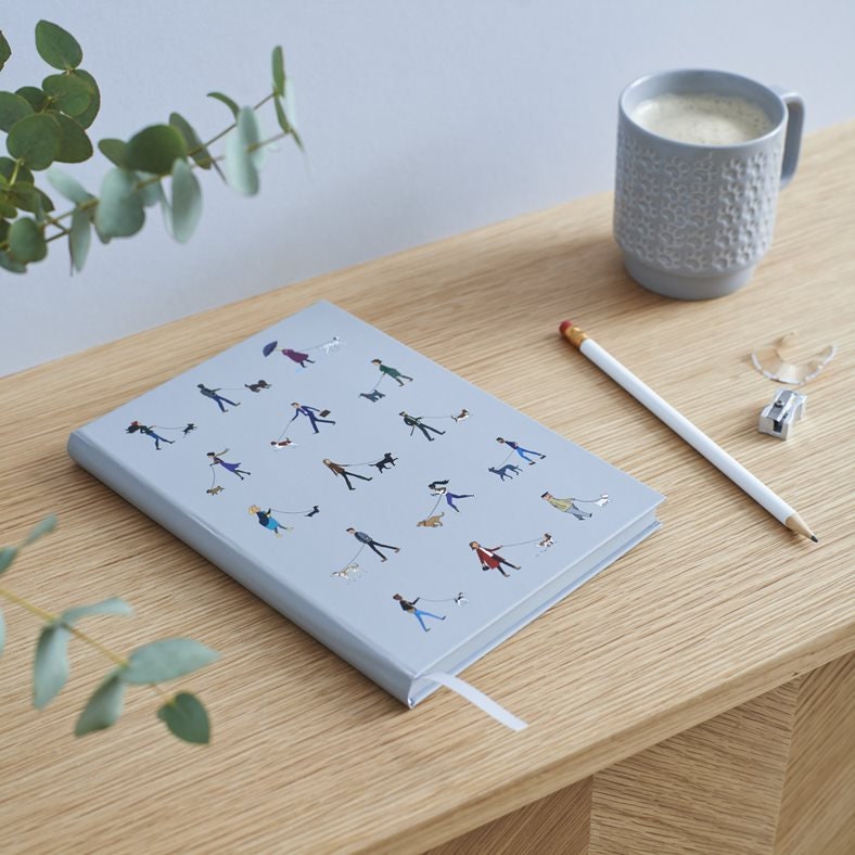 Dog Walker's Notebook laid flat on wooden desk — illustrated dog walkers cover, A5 hardback notebook, dog lover gift by Sweet William Designs