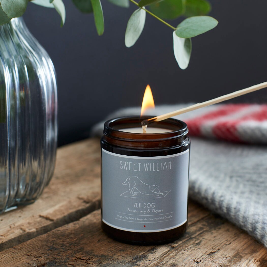Zen Dog soy wax candle being lit with a match — rosemary and thyme scented, calming dog lover gift by Sweet William Designs