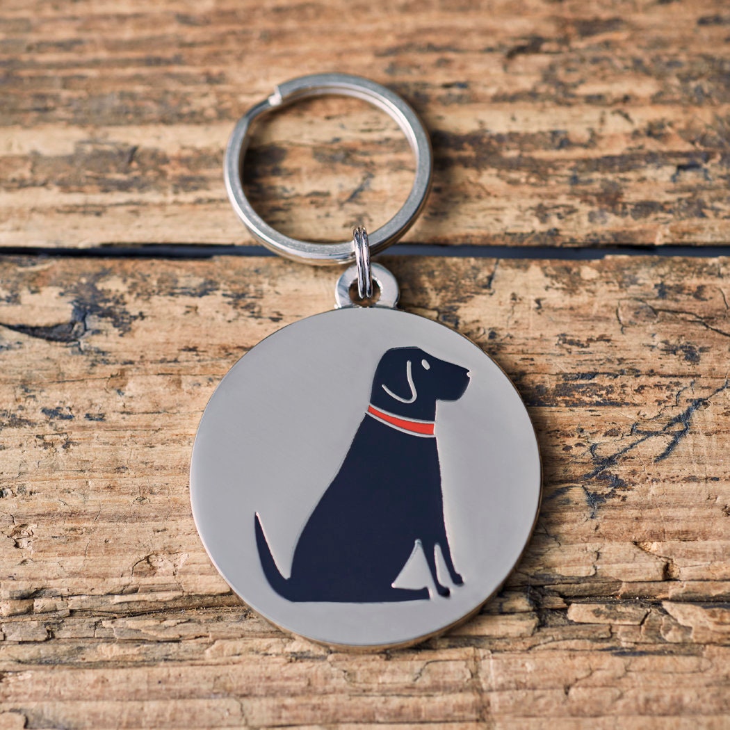 Close-up of Black Labrador dog ID tag — silver-plated brass with illustrated Black Lab design, personalised dog tag by Sweet William Designs