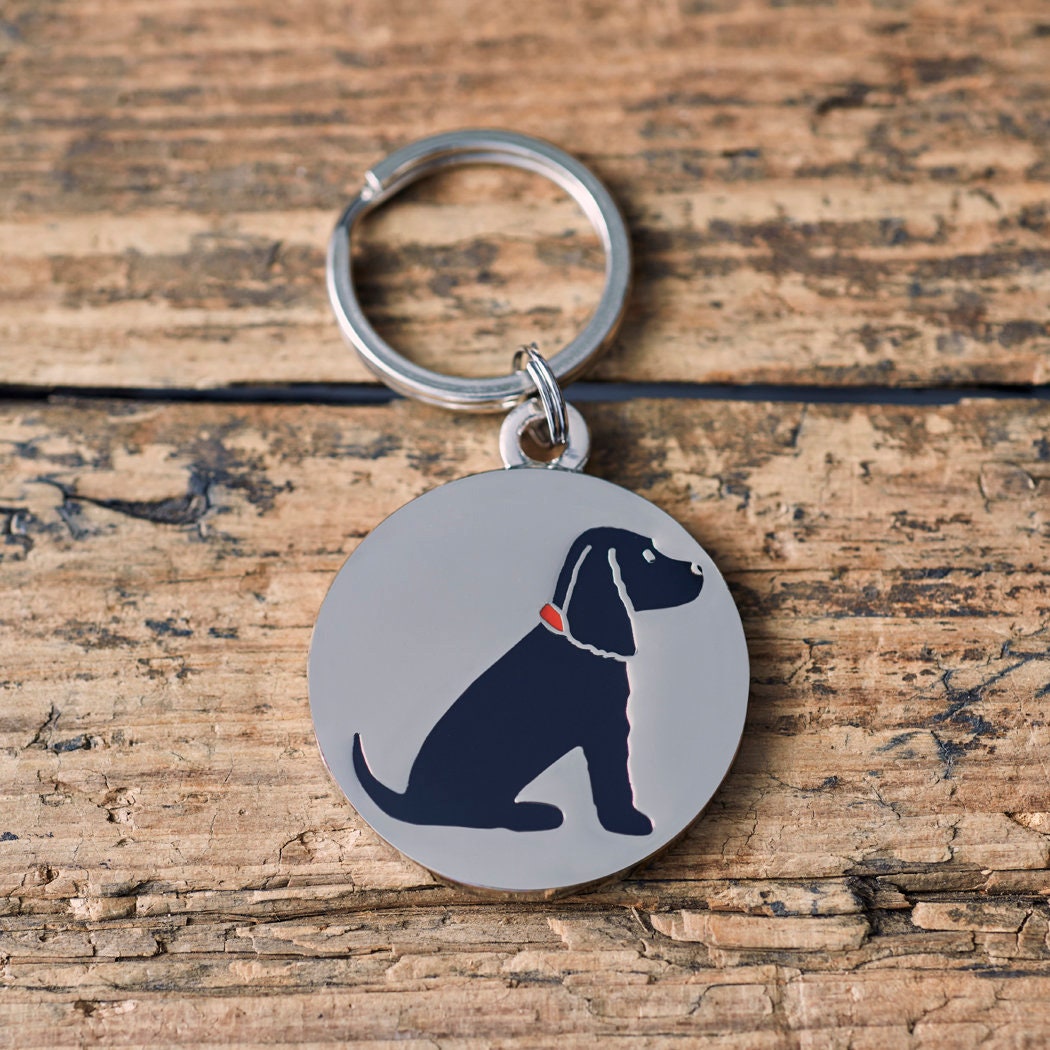 Close-up of Black Cocker Spaniel personalised dog tag — silver-plated brass with illustrated Cocker Spaniel design, personalised dog lover gift by Sweet William Designs