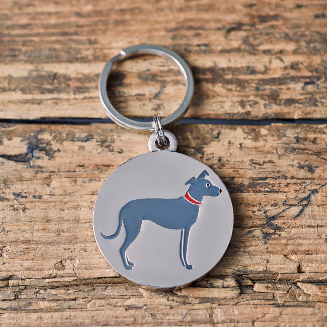 Close-up of Lurcher dog ID tag — silver-plated brass with illustrated Lurcher design, personalised dog tag by Sweet William Designs