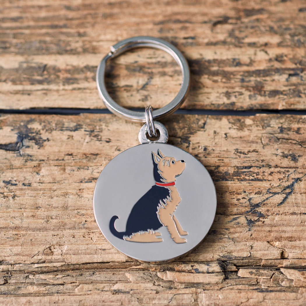 Close-up of Yorkshire Terrier dog ID tag — silver-plated brass with illustrated Yorkie design, personalised dog tag by Sweet William Designs